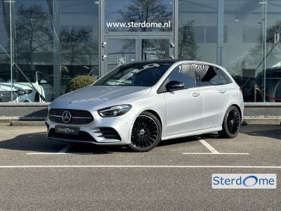 Mercedes-Benz B-Klasse 200 amg line l distronic l panoramaschuifdak l mbux l achteruitrijcamera l multispaaks l sportief motorgeluid l keyless l stoelverwarming l multibeam l draadloos opladen voor l